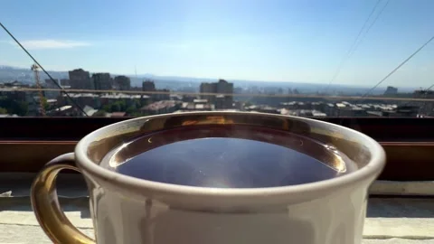 Backlight illuminate sun shine close-up steaming hot tea cup, slow motion. Stock Footage 319422434
