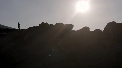 Backlight people on volcano crater 스톡 동영상 233711366
