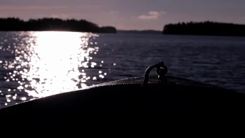 Backlight shot of the bow of a motorboat heading towards sun Stock Footage 70097848