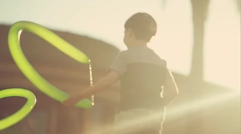 Backlight shot of kid playing with balloon at park Stock Footage 49615512