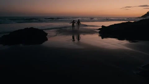 Backlight sunset, couple on the beach, slow motion Stock Footage 134438341