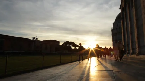 Backlight at sunset by people walking in Piazza dei Miracoli, Pisa. Stock Footage 31061073