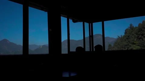 Backlight from the window with a view of the mountainous area and blue sky Stock Footage 293653131