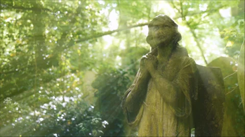 Backlit angel statue, with camera move. Video stock 29785176