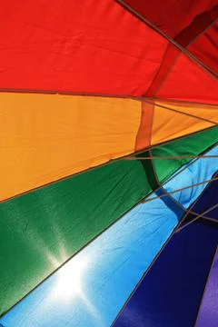 Backlit beach umbrella Stock Photos