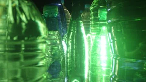 Backlit bottled water, different plastic bottles Stock Photos