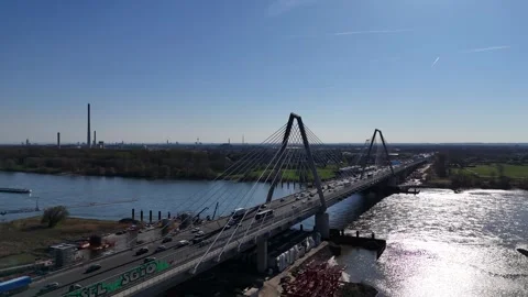 Backlit bridge with distant skyline and river vessel Stock Footage 331200823