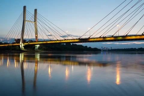 Backlit bridge at night and reflected in the water Stock Photos