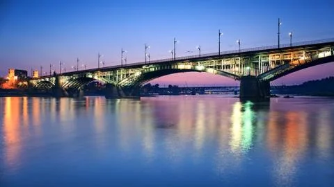 Backlit bridge at night and reflected in the water Stock Photos