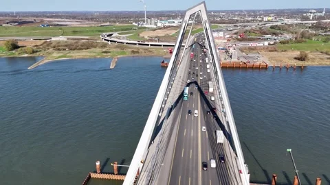 Backlit bridge towers casting shadows on roadway Stock Footage 331200925