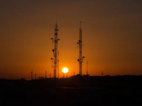 Backlit of cellular antenna tower Stock Photos