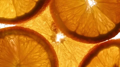 Backlit citrus slices with bubbles in fresh summer drink texture Vidéo 331259566
