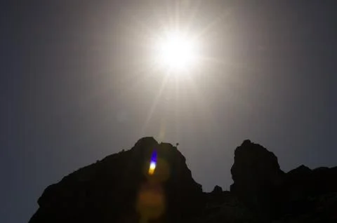 Backlit cliff with a dragon tree of Gran Canaria. Stock Photos