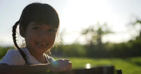 Backlit Close up shot, Cute asian girl laughing happily playing with guitar 스톡 동영상 219598748