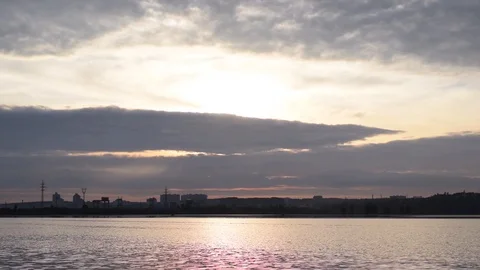 Backlit clouds in gorgeous sky over river and city Stock Footage 87857327