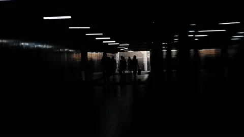 Backlit crowd of people walks along the underpass Stock Footage 199764798