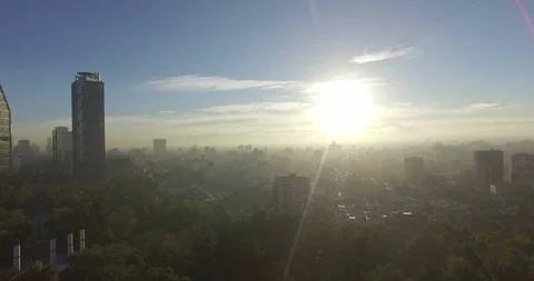 Backlit drone reveal of Chapultepec Castle starts with Mexico City skyline. Video stock 126048607