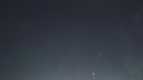 Backlit dust particles with bubble like bokeh floating in slow motion Stock Footage 69959265