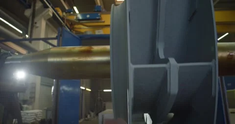Backlit Fan Wheel and Drive Shaft, Dark Factory Interior, Low Angle Shot Stock Footage 340354965