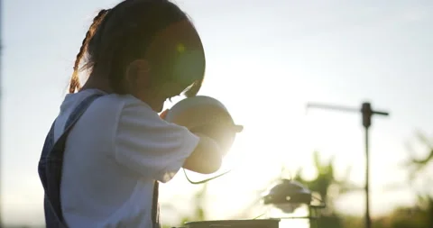Backlit Handheld Close up shot, Cute little girl enjoy play to cooking in pot 스톡 동영상 219599314
