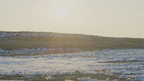 Backlit Ice and Snow on Ground with Cold Winter Mood Stock Footage 326370779