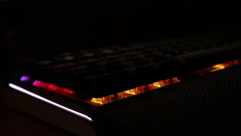 Backlit keyboard at home. Colored light. Mechanical keyboard. Working office. Video stock 129810478