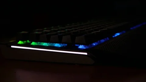Backlit keyboard at home. Colored light. Mechanical keyboard. Working office. Video stock 129810481