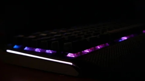 Backlit keyboard at home. Colored light. Mechanical keyboard. Working office. Video stock 129810504
