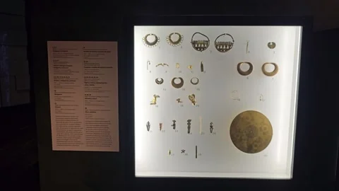 Backlit Panel of Small Gold Ornaments and Disc, Colombia 8K Stock Footage 331514372