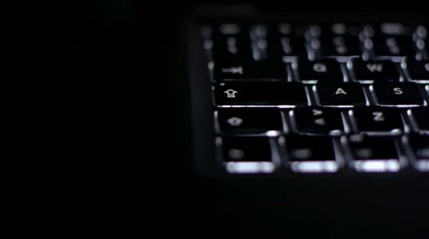 Backlit pc keyboard tracking shot Stock Footage 1043964