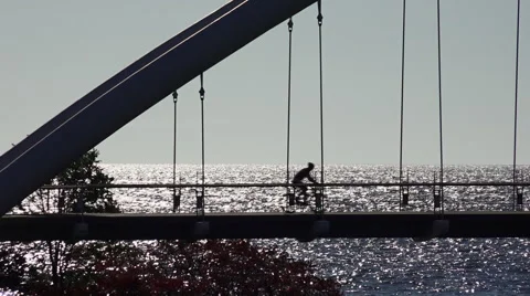 Backlit Pedestrian Suspension Bridge Stock Footage 55889115