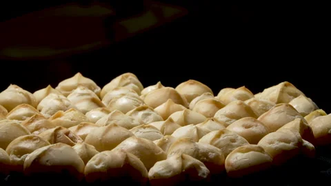 Backlit Peeled Macadamia Kernels Rotating on Black. Video stock 332835199