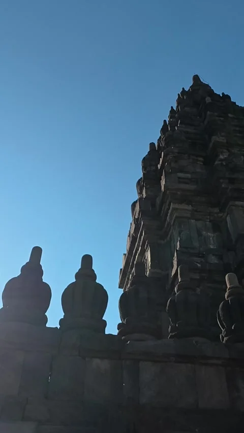 Backlit Prambanan Temple tower and sculpted pinnacles form a dramatic silho.. Stock Footage 341543133
