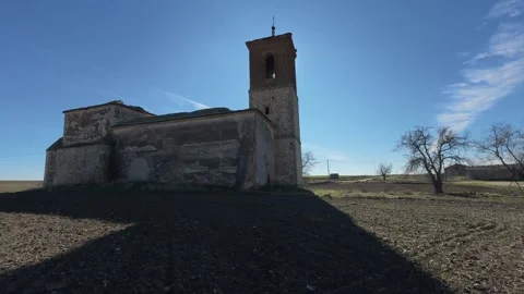 Backlit pullback of ruined church with blocked entrance and tower silhouette Video stock 333939932
