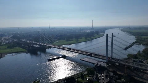 Backlit Rhine bridge with passing river vessel Видео 335364012