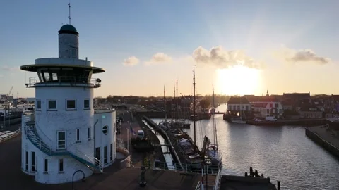 Backlit round harbor control building with dramatic sun rays Stock Footage 331843638
