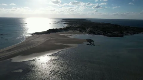Backlit sandbar and sun glitter at Elafonisi, aerial, Crete Stock Footage 346723501