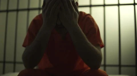Backlit scene of a depressed inmate in prison Stock Footage 59758983