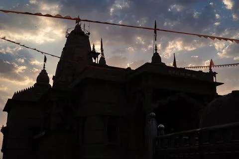 Backlit shot of dramatic sunset sky and artistic hindu temple at evening fr.. Stock-Fotos