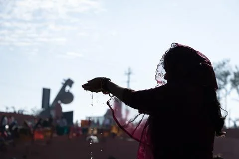 Backlit shot of young devotee praying for holy god after bathing in holy ri.. Stock Photos