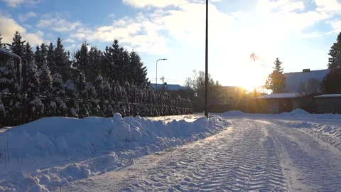 Backlit Snowflakes Rising Over Plowed Winter Street at Sunset Stock Footage 328137686