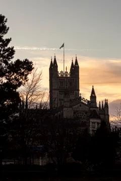 A backlit sunset view of the tower part of the historic Bath Abbey. Stock Photos