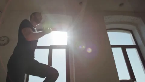 Backlit tracking left shot of young male athlete doing high knees exercise in Stock Footage 172497779