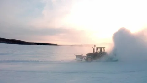 Backlit Tractor Blowing Snow Under the Winter Sun Stock Footage 344955986