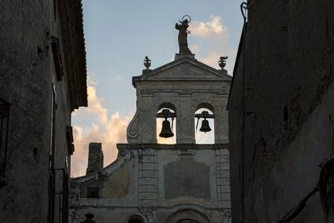 Backlit two old bells of an ancient church in Italy. 스톡 사진