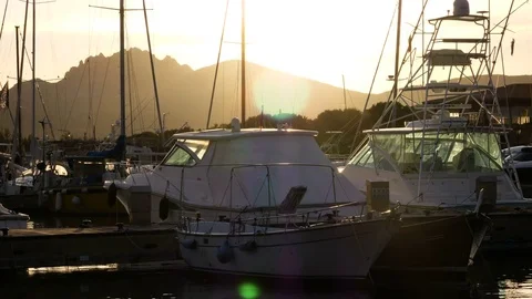 Backlit view of boats docked in Porto Rotondo at the sunset. Stock Footage 79453260