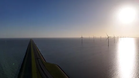 Backlit view of dam curve and turbines over shimmering water Stock Footage 331838533
