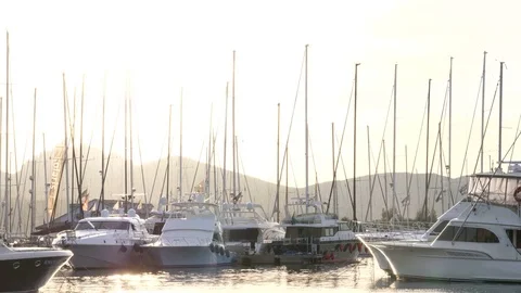 Backlit view of power and sailing boats docked in Porto Rotondo. Stock Footage 79451950