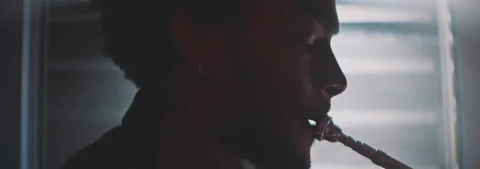 Backlit view of a trumpeter playing Stock Footage 202309426