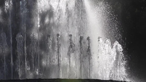 Backlit water flowing with reflections and splashes. Fountain in Milan, Italy Vídeo Stock 129404688